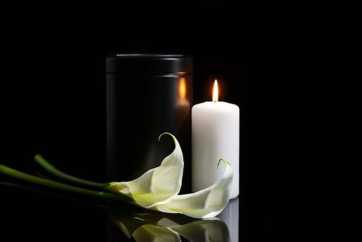burning-candle-with-lily-and-urn
